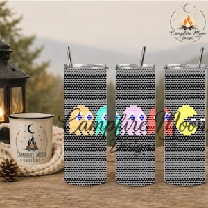 May include: Three tall cylindrical tumblers with lids and straws, featuring a black and white honeycomb pattern background. The tumblers display colorful pixelated ghost and circular character graphics in yellow, teal, pink, and red.