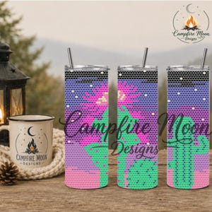 May include: Three cylindrical tumblers with metal straws featuring a repeating hexagonal pattern design. The graphic depicts a green cactus against a purple and pink sunset sky with small yellow stars and a black top border. The logo Campfire Moon Designs is visible.