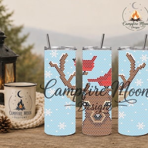 May include: Three cylindrical tumblers with a light blue background featuring a repeating pattern of white snowflakes, a brown reindeer face, and red birds. Each tumbler includes a silver lid and a matching metal straw for drinking beverages.