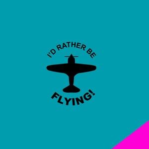 May include: A teal background with a black silhouette of a vintage airplane. The text "I'D RATHER BE FLYING!" is in black, arching above and below the plane. A diagonal pink stripe is in the lower right corner.