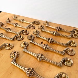 Set of ELEVEN brass drawers pulls