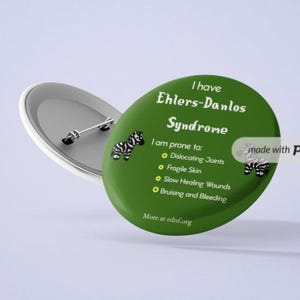 May include: Green button with a zebra graphic and the text "I have Ehlers-Danlos Syndrome. I am prone to: Dislocating Joints, Fragile Skin, Slow Healing Wounds, Bruising and Bleeding. More at ednf.org."