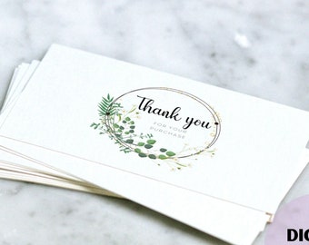 May include: A stack of white thank you cards with a gold circle and green floral design. The text "Thank you for your purchase" is inside the circle.