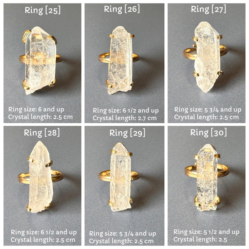 May include: Six gold rings, each with a clear, elongated crystal. The rings are displayed on a grey surface. The crystal lengths vary from 2.5 cm to 2.7 cm. Ring sizes are 6 and up, 6 1/2 and up, and 5 3/4 and up. The image includes text indicating ring size and crystal length.