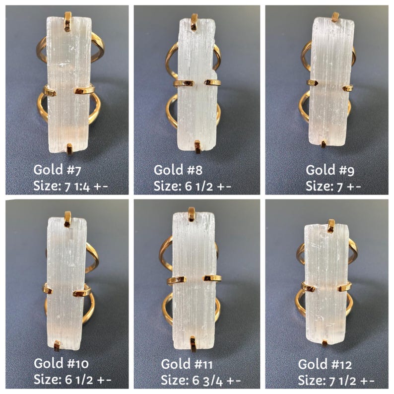 May include: Six gold-toned rings featuring rectangular, translucent white selenite crystals held by metal prongs. Each ring is labelled with a number and a size in inches, ranging from 6 1/2 to 7 1/2, indicating specific ring sizes for each individual piece.