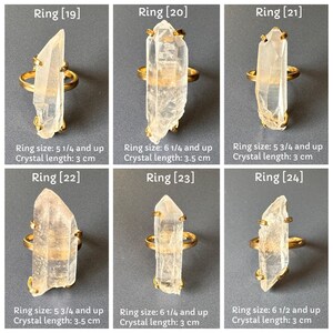 May include: Six gold rings, each with a clear quartz crystal. The crystal lengths range from 3 cm to 3.5 cm. The image text indicates ring sizes from 5 1/4 and up to 6 1/2 and up. The rings are displayed on a grey background.