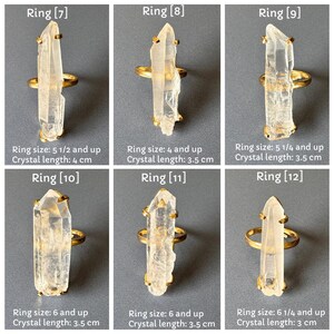 May include: Six quartz crystal rings with gold-tone metal settings. Each ring has a clear, elongated crystal. Ring sizes and crystal lengths are shown. The rings are displayed on a grey surface. Crystal lengths range from 3 cm to 4 cm.