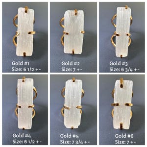 May include: Six gold-toned rings featuring rectangular, translucent white selenite crystals held by four prongs. Each ring is labelled with a number from 1 to 6 and a size ranging from 6.5 to 7.75, indicating specific variations in the crystal shape.