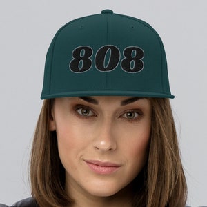 May include: A set of three ceramic mugs with a speckled, matte finish. The mugs are in shades of cream, light gray, and dark gray. Each mug has a simple, minimalist design, perfect for coffee or tea.