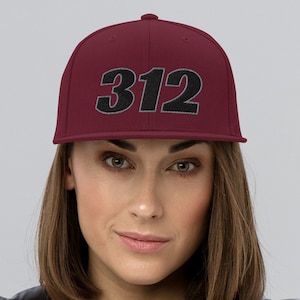 May include: A set of three ceramic mugs with a speckled, cream-colored glaze. Each mug features a different hand-painted floral design in shades of blue, green, and yellow. The mugs have a simple, rounded shape and a comfortable handle.