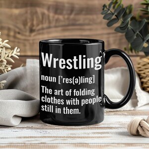 May include: A set of three ceramic mugs with a speckled, matte finish. The mugs are in shades of cream, light gray, and dark gray. Each mug has a simple, modern design and a rounded handle. The mugs are stacked on top of each other.