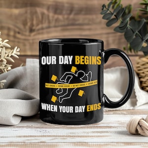 May include: Black ceramic mug with a humorous crime scene design. The mug features the text "OUR DAY BEGINS WHEN YOUR DAY ENDS" with a crime scene outline and yellow caution tape. A perfect gift for law enforcement or true crime enthusiasts.