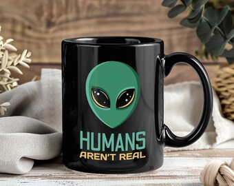 Taza "Los humanos no son reales" - Taza divertida de café/té con diseño de ovni, platillo volador extraterrestre, regalo para amantes del espacio y entusiastas de los extraterrestres.