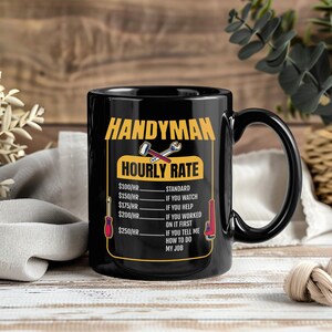 May include: Black ceramic mug with the text "HANDYMAN HOURLY RATE" in yellow. The mug features a humorous breakdown of hourly rates based on the level of assistance provided, with tool graphics. A fun gift for a handyman.