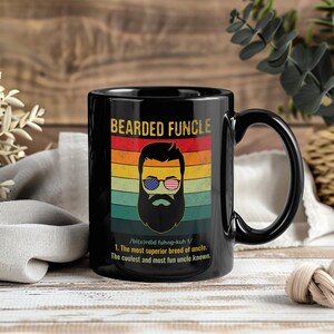 May include: Black ceramic mug with the text "BEARDED FUNCLE" and a graphic of a bearded man wearing American flag sunglasses. The mug also includes a definition of "FUNCLE".