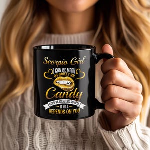 May include: Black ceramic mug with the text "Scorpio Girl" in gold script. The mug features a gold lip graphic and the words "Candy", "Gold as Ice & Evil as Hell", and "It All Depends on You".