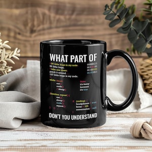 May include: Black ceramic mug with the text "WHAT PART OF DON'T YOU UNDERSTAND" and programming code. The mug features a black handle and a white interior. The mug is designed for programmers and computer science enthusiasts.