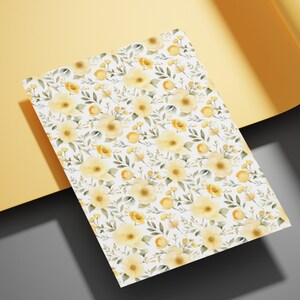May include: A white background with a repeating pattern of yellow watercolor flowers and green leaves.