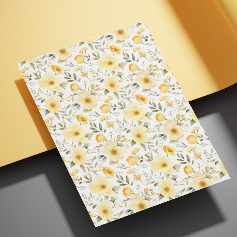 May include: A white background with a repeating pattern of yellow watercolor flowers and green leaves.