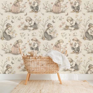 Seamless pattern in a vintage storybook toile style featuring girls picking pretty wildflowers. Soft ink and watercolor illustration in muted tones of sandy beige, pale blue, and warm grey.