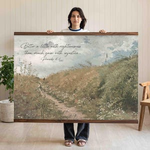 以下が含まれることがあります： 緑、茶色、青の落ち着いた色調の風景画が描かれた、大きな長方形のウォールアートプリント。アートワークは、フィールドを通る小道が特徴で、「Better a little with righteousness than much gain with injustice」と「Proverbs 16:8」のテキストが書かれています。プリントは濃い木材で額装されています。