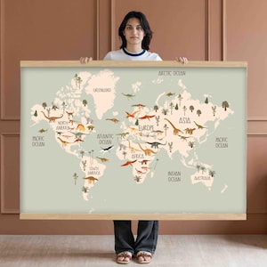 May include: A world map featuring a light green background with continents and oceans labeled. The map is decorated with various dinosaur illustrations. The map is framed with a light brown wooden frame.
