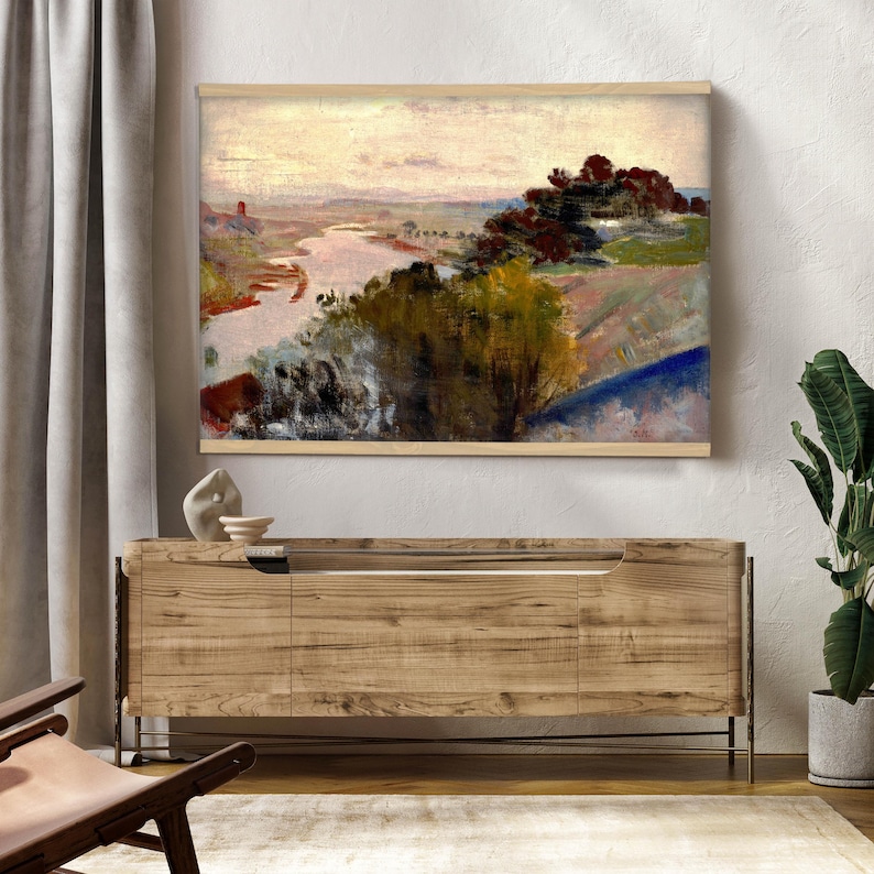 May include: A rectangular wall art print featuring an impressionist landscape painting of a winding river flowing through a valley with dense trees in the foreground, set against a soft, pale sky with warm, muted tones of brown, green, and cream.