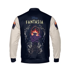 May include: Navy blue and cream-colored bomber jacket featuring a graphic from Disney's Fantasia. The back of the jacket displays a purple demon with a fiery head, surrounded by skeletons. The sleeves are cream-colored, and the jacket has a classic bomber style.