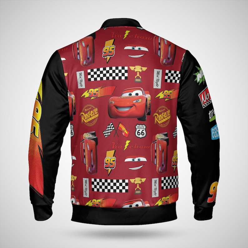 May include: A red and black bomber jacket featuring a pattern of the character Lightning McQueen from the movie Cars. The jacket has black sleeves and a red body with various graphics, including the number 95, checkered flags, and the Route 66 sign.