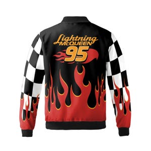 Pu&ograve; includere: Giacca bomber nera con design Lightning McQueen. La giacca presenta un motivo a fiamme rosse e arancioni, il numero 95 e il logo Lightning McQueen. Le maniche hanno un motivo a scacchi bianco e nero.