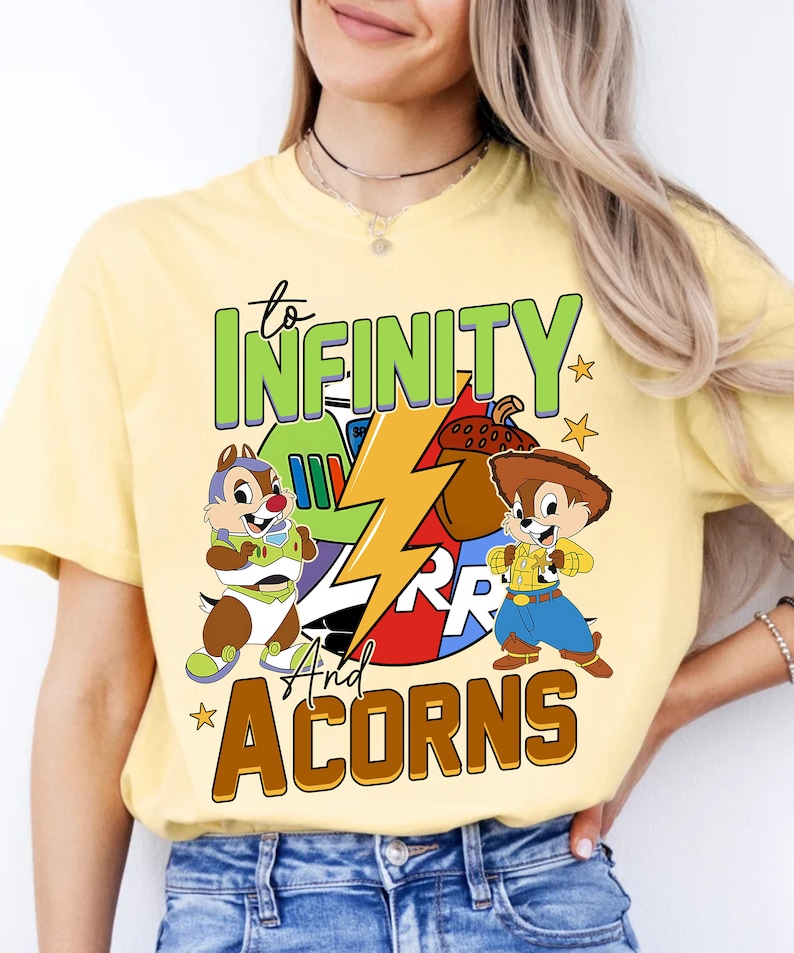 May include: Yellow t-shirt featuring a cartoon image of Chip 'n Dale. The shirt has the text "to infinity and acorns" with a lightning bolt graphic.