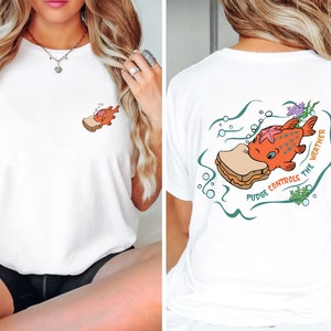 May include: White t-shirt with a cartoon fish eating a peanut butter and jelly sandwich. The text on the shirt reads "Pudge Controls the Weather".