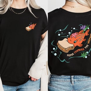 May include: Black t-shirt with a cartoon fish eating a sandwich on the back. The text "Pudge Controls The Weather" is printed around the fish. The front of the shirt has a small image of the fish eating a sandwich.