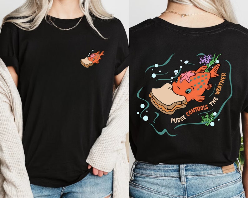 May include: Black t-shirt with a cartoon fish eating a sandwich on the back. The text "Pudge Controls The Weather" is printed around the fish. The front of the shirt has a small image of the fish eating a sandwich.
