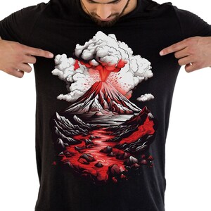 May include: A black t-shirt with a graphic print of a volcano erupting with red lava and white smoke.