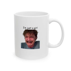 May include: White ceramic mug with a black and white image of a person crying and the text "I'm just a girl".
