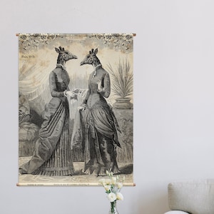 以下が含まれることがあります： キリンの頭をつけた2人の女性が長いドレスを着て庭園に立っているヴィンテージイラスト。イラストはキャンバスに印刷され、リビングルームの壁に飾られています。