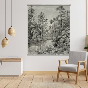 May include: Black and white illustration of a tropical jungle scene with palm trees, ferns, and a river. The illustration is framed and hanging on a white wall.