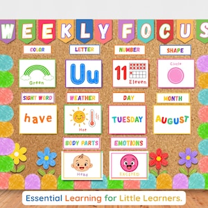 May include: A cork-textured educational poster titled WEEKLY FOCUS with colorful banners. It features sections for color, letter, number, shape, sight word, weather, day, month, body parts, and emotions, decorated with flowers and crayon-style borders.