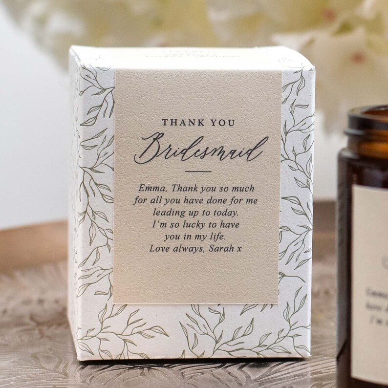 May include: A white box with a floral pattern and a beige label that says "Thank You Bridesmaid". The label also includes a message thanking the bridesmaid for all she has done and saying "Love always, Sarah x".