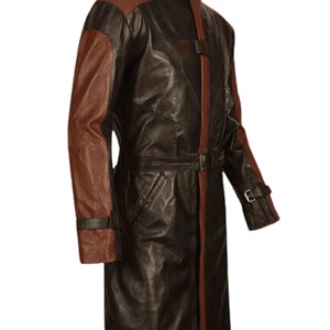 May include: A long brown leather coat with brown leather sleeves. The coat has a belt and a high collar.