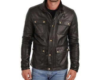 May include: A dark brown leather jacket with four front pockets and gold-colored buttons. The jacket has a collar and a zipper closure. The sleeves are long and fitted. The jacket is worn over a black shirt.