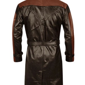 May include: A long brown leather coat with brown leather accents on the sleeves and collar. The coat has a belt and a stand-up collar.
