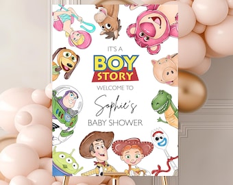 May include: A gold easel displays a "Toy Story" themed baby shower sign. The sign features cartoon characters and the text "It's a Boy Story" and "Welcome to Sophie's Baby Shower". Balloons in shades of pink and gold decorate the background.