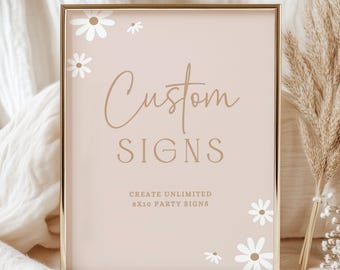 May include: A framed sign with the words "Custom SIGNS" in a stylish font. The sign is a soft peach color with white daisy accents. The frame is gold. The text "CREATE UNLIMITED 8x10 PARTY SIGNS" is at the bottom.