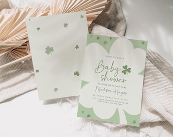 May include: A green and white baby shower invitation with shamrock designs. The invitation reads "Join us for a Baby Shower Honoring the Parents-to-Be Madison Hayes Saturday, March 15th at 3PM 123, Town St, Southville, Mary's Da 589 RSVP Alice at 123-456-7885"