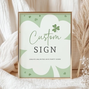 May include: A gold-framed sign with a green shamrock design. The sign says "Custom Sign" and "Create Unlimited 8x10 Party Signs".