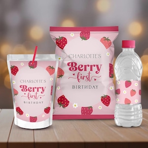 May include: A set of pink party supplies with a strawberry theme, including a drink pouch, a snack bag, and a water bottle. The text reads "Charlotte's Berry First Birthday."