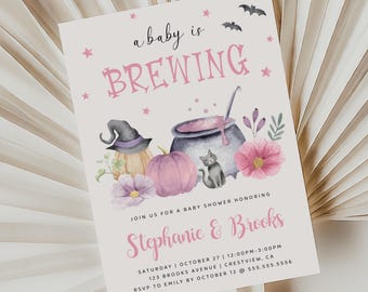 May include: A pink and white baby shower invitation with a witch's cauldron, pumpkins, and a black cat. The text reads "a baby is BREWING" and "Stephanie & Brooks".