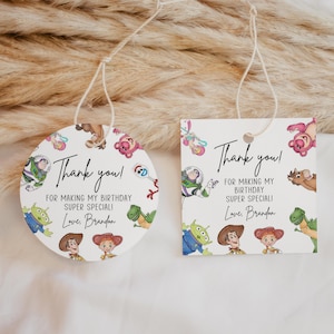 May include: Two white gift tags with a string, one round and one square, featuring Toy Story characters. The tags say "Thank you!" and "For making my birthday super special!" with the name "Brandon".